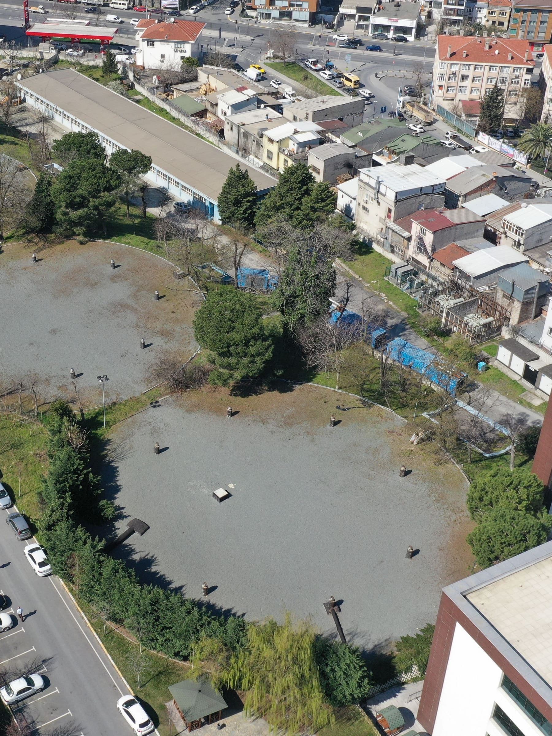 An undeveloped block of ground in Eyüpsultan, İstanbul, held open inside a completed district, with road frontage along two edges and dense built stock immediately behind it.